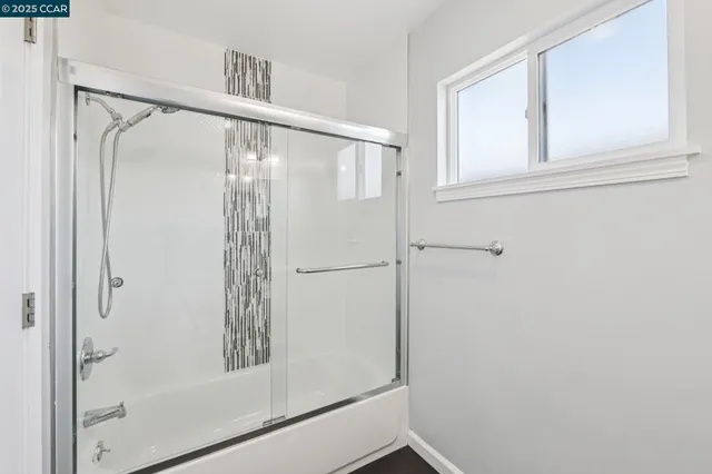 a bathroom with a glass shower door