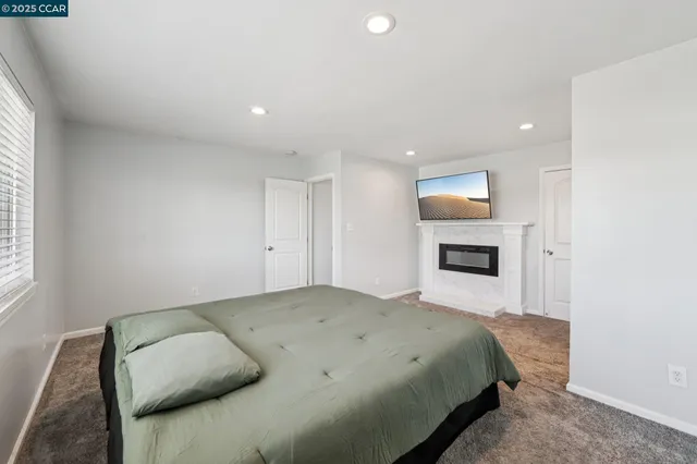 a spacious bedroom with a bed and a couch