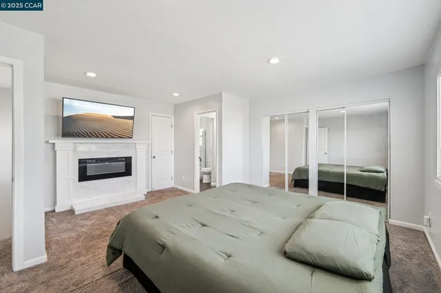 a spacious bedroom with a bed and a fireplace