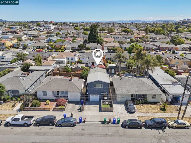an aerial view of residential houses and outdoor space