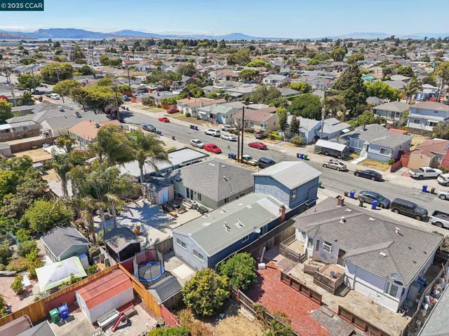 an aerial view of a house with a mountain