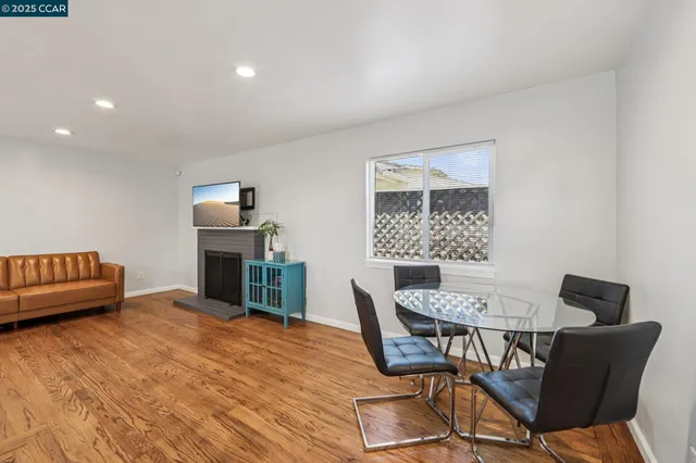 a view of a dining room with furniture and a fireplace