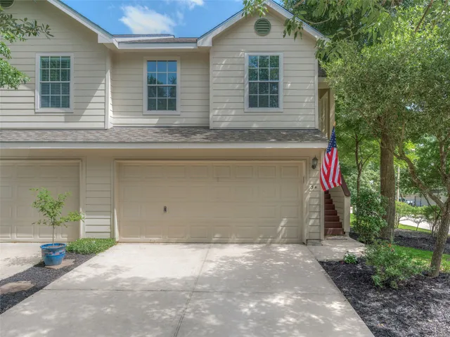 a front view of a house with a yard and a garage