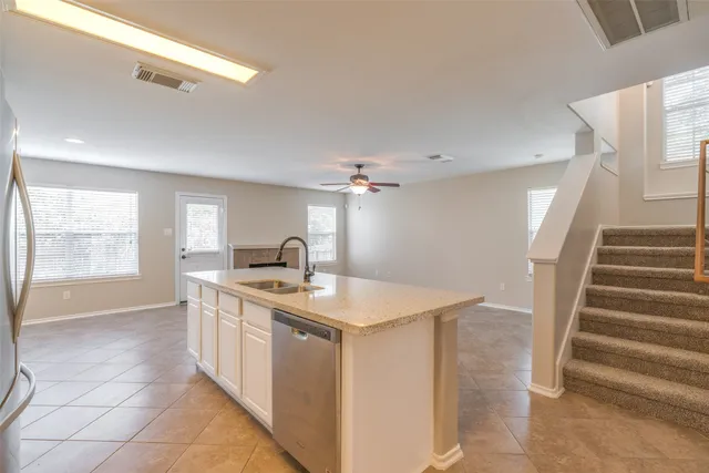 a kitchen with a sink and a stove top oven