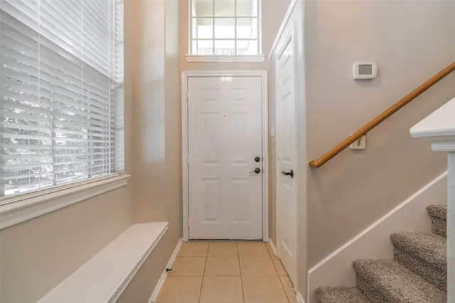 a view of a hallway with windows and stairs
