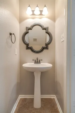 a bathroom with a sink and mirror