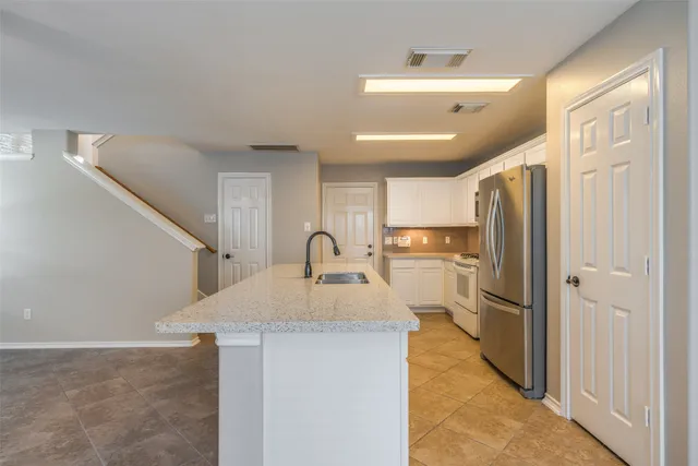 a kitchen with refrigerator and window