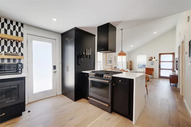 a kitchen with stainless steel appliances granite countertop a stove and a refrigerator