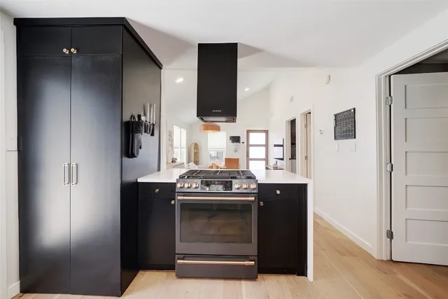 a kitchen with stainless steel appliances granite countertop a stove and a refrigerator