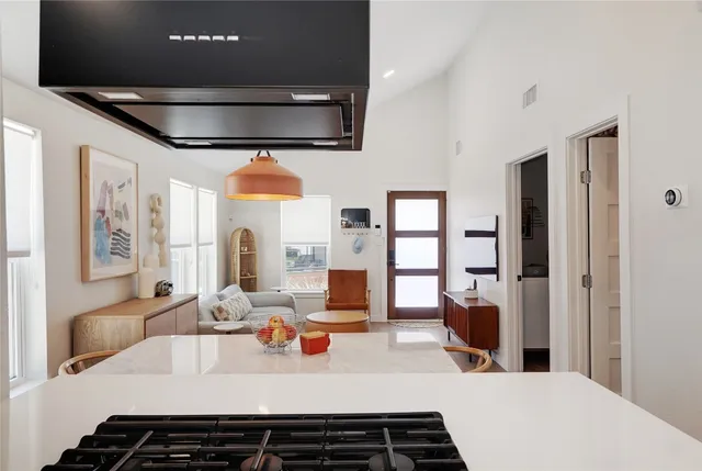 a large kitchen with a table and chairs