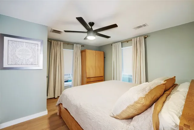 a bedroom with a large bed and a chandelier