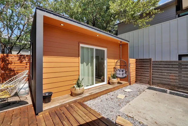 a backyard of a house with basket ball court