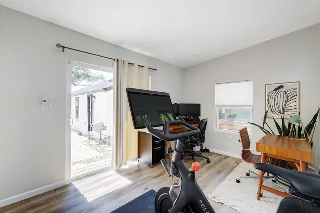 a view of a workspace with furniture and a window