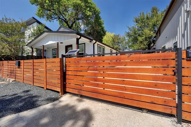 a front view of house with a garden