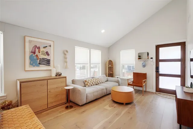 a spacious bedroom with a bed a couch and a window