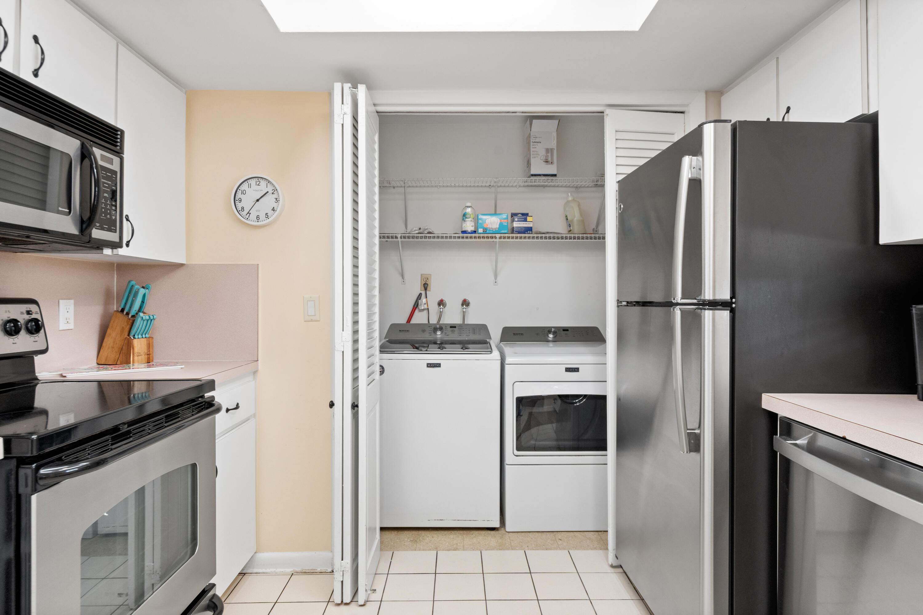 249 Center Street, Unit 2C Jupiter, FL 33458 - Photo 17 of 29 a kitchen with stainless steel appliances a refrigerator stove and microwave
