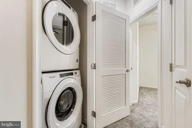 a view of a hallway with washer and dryer