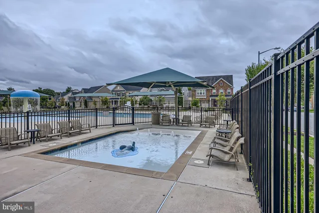 a view of swimming pool with outdoor seating and plants