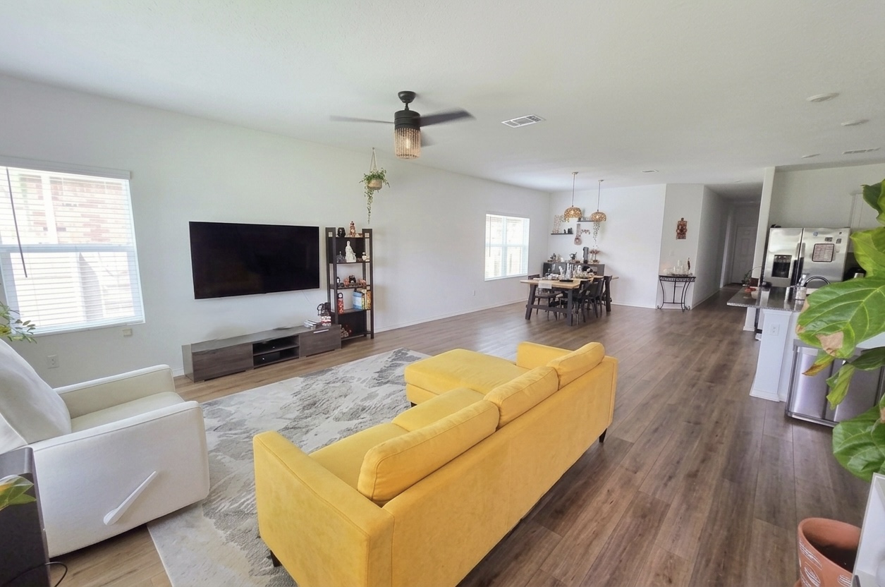 208 Wolf Springs Road Georgetown, TX 78628 - Photo 5 of 32 An open-concept living space with sleek flooring and natural illumination for comfortable gatherings.