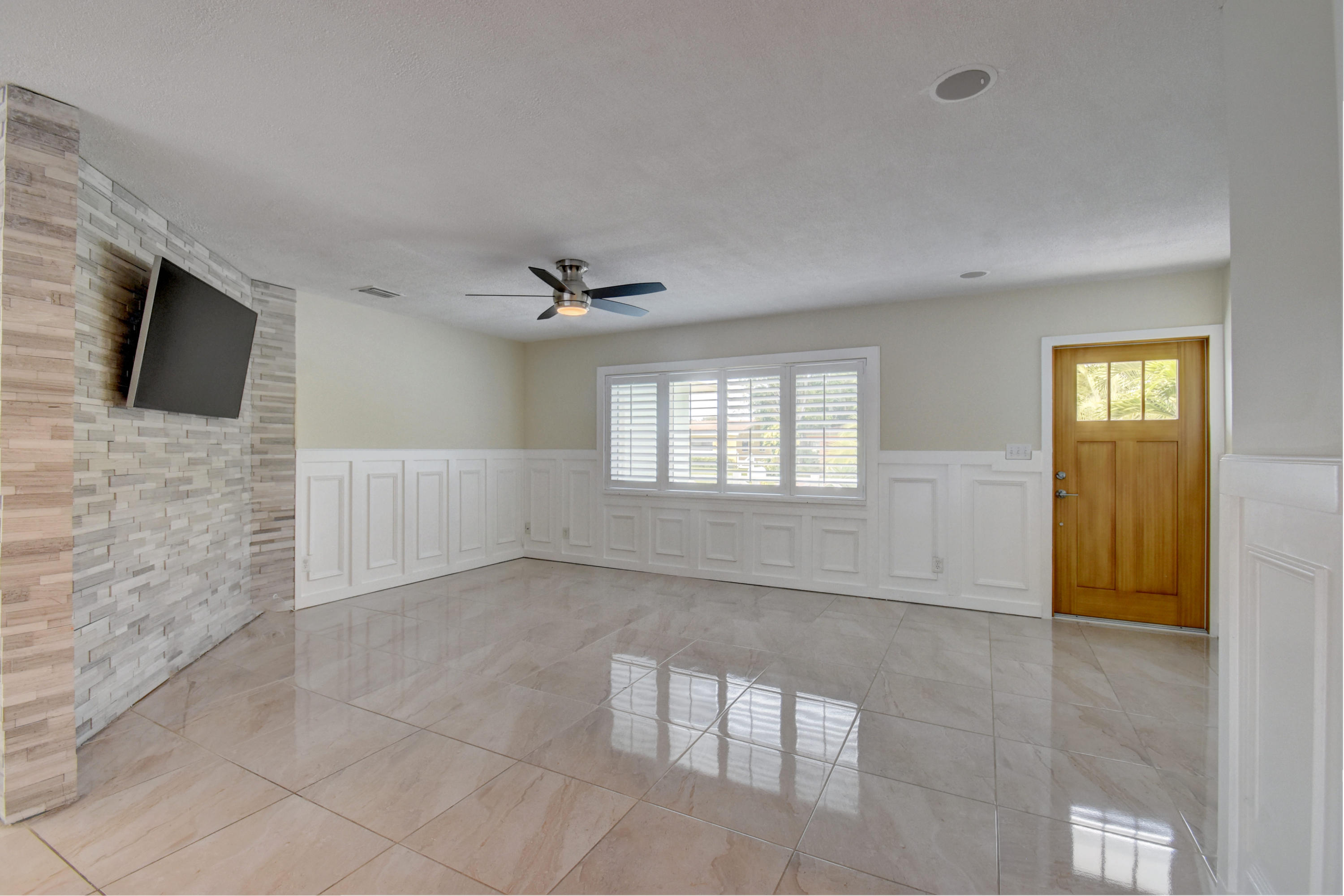 1266 Southwest 5th Street Boca Raton, FL 33486 - Photo 3 of 30 a view of an empty room with a fireplace and a window