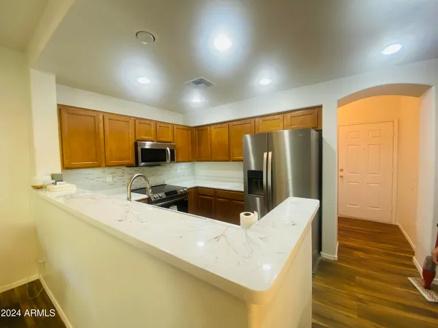 a kitchen with stainless steel appliances a sink a stove and refrigerator