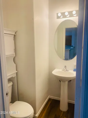 a bathroom with a sink toilet and mirror
