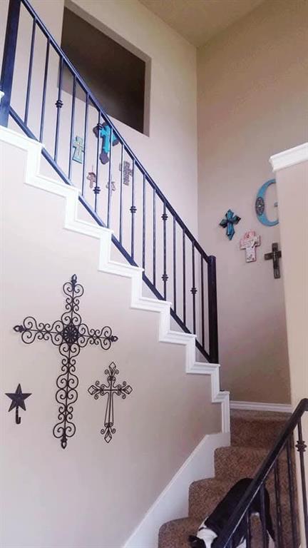 1118 Elk Ridge Drive Stephenville, TX 76401 - Photo 13 of 40 a view of staircase with lots of frames on wall and a window