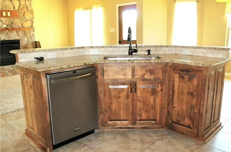 1118 Elk Ridge Drive Stephenville, TX 76401 - Photo 32 of 40 a view of a kitchen with a sink and a window