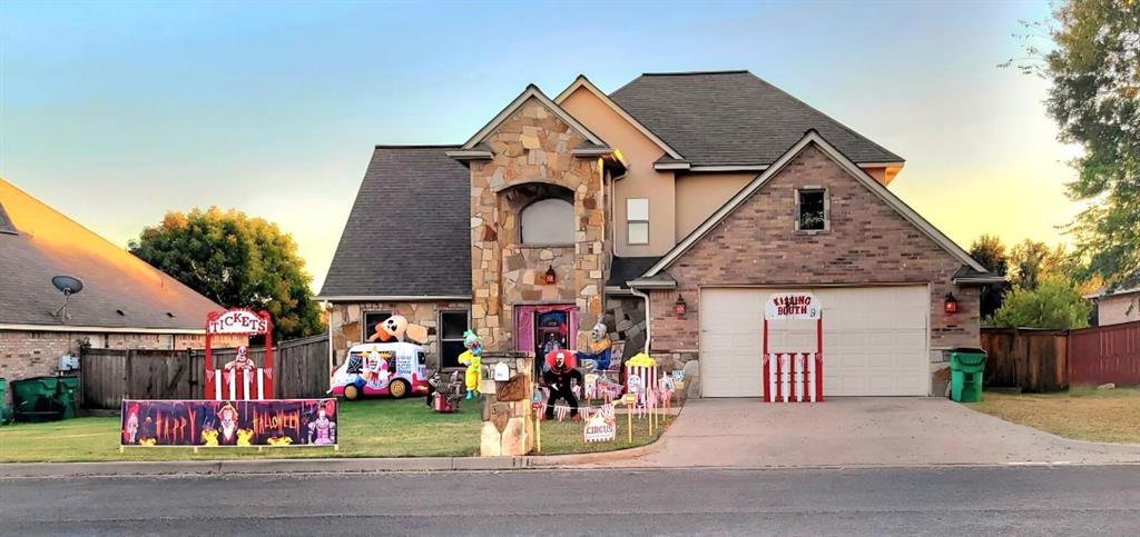 1118 Elk Ridge Drive Stephenville, TX 76401 - Photo 33 of 40 a group of people sitting in front of a house