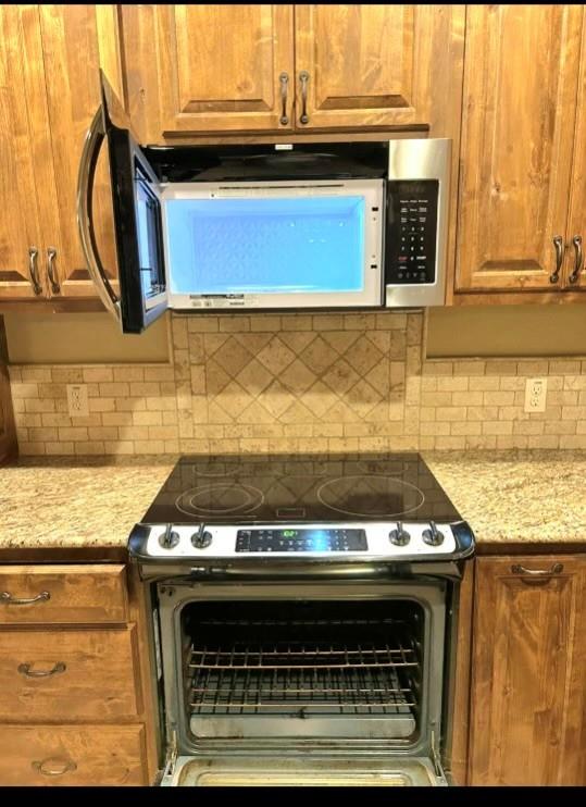 1118 Elk Ridge Drive Stephenville, TX 76401 - Photo 38 of 40 a stove top oven sitting inside of a kitchen