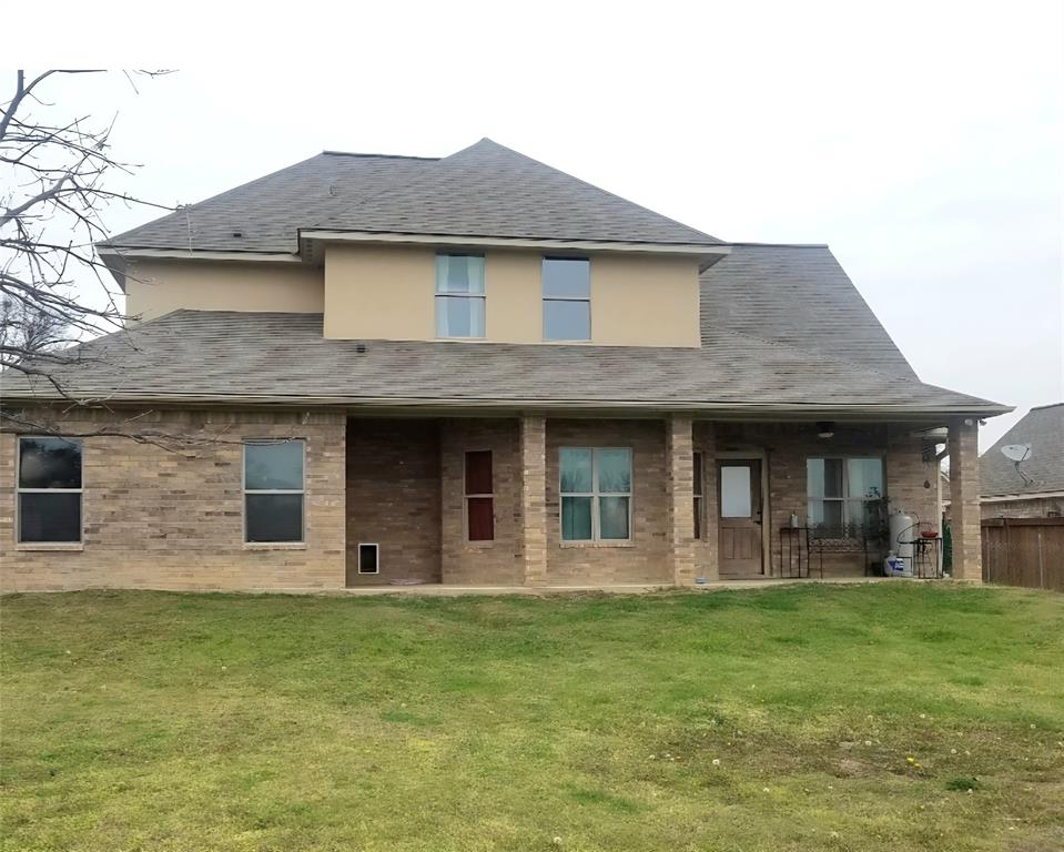 1118 Elk Ridge Drive Stephenville, TX 76401 - Photo 4 of 40 a view of a brick house with a large windows