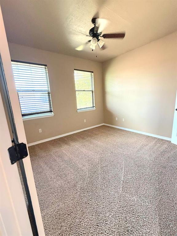 1118 Elk Ridge Drive Stephenville, TX 76401 - Photo 5 of 40 an empty room with windows and fan