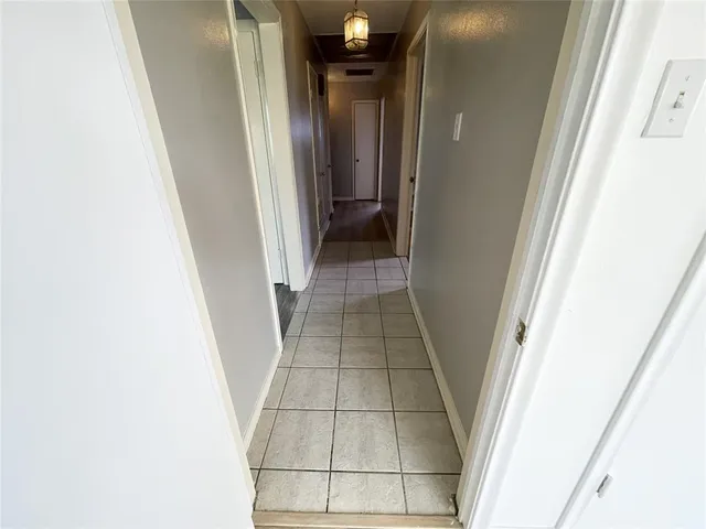 a view of a room with wooden floor and ceiling fan