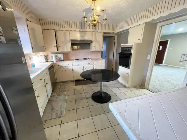 a view of a livingroom with furniture and a ceiling fan