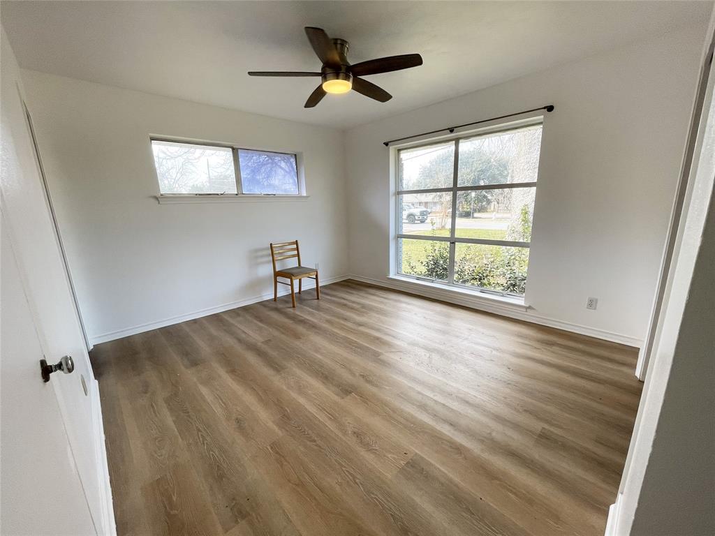203 Abrams Road Richardson, TX 75081 - Photo 9 of 29 a view of empty room with wooden floor and fan