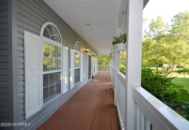 a view of a balcony with wooden floor