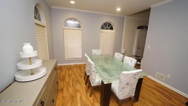 a dining room with wooden floor and a table