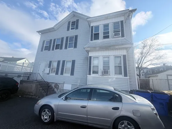 a front view of a house with parking space