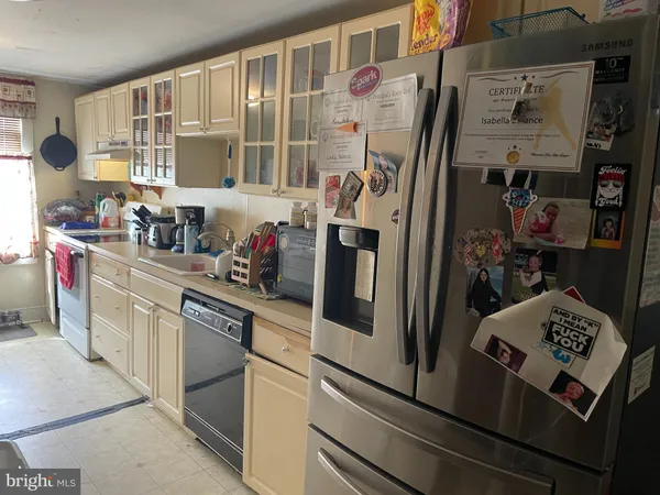 a kitchen with stainless steel appliances granite countertop a refrigerator and sink