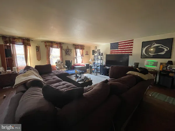 a living room with furniture window and wooden floor