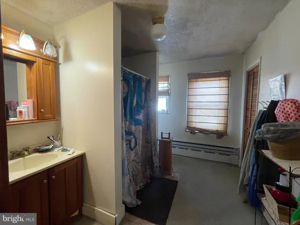 a bathroom with a sink a mirror and a shower