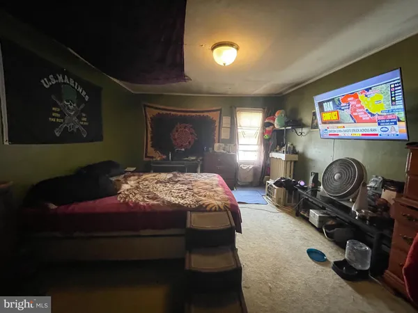 a bedroom with furniture and a flat screen tv