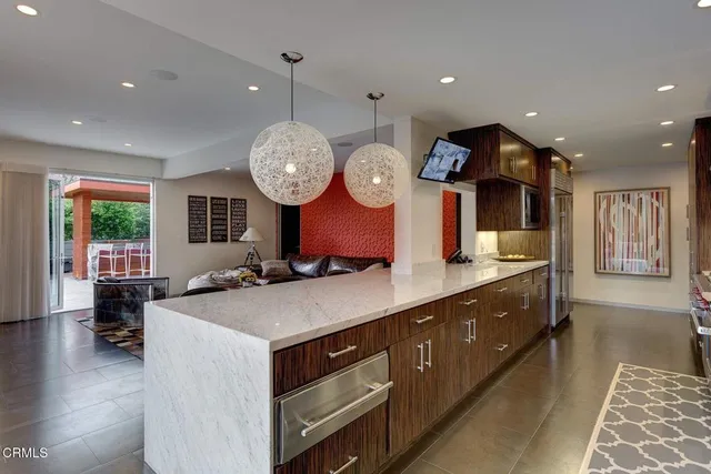 a kitchen with a sink and a clock on the wall