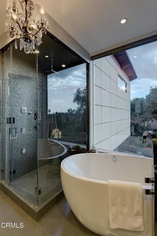 a bathroom with a bathtub and a shower