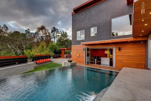 a view of swimming pool with seating space and lake view