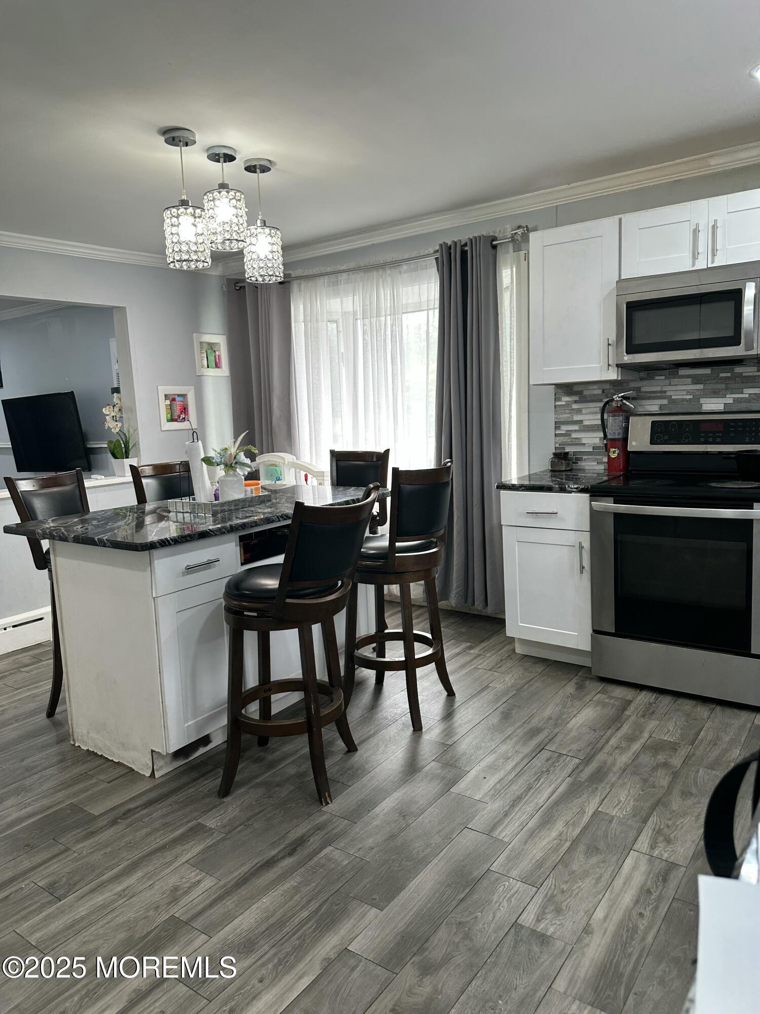 308 Myrtle Street Cliffwood, NJ 07721 - Photo 17 of 44 a view of a dining room with furniture window and wooden floor