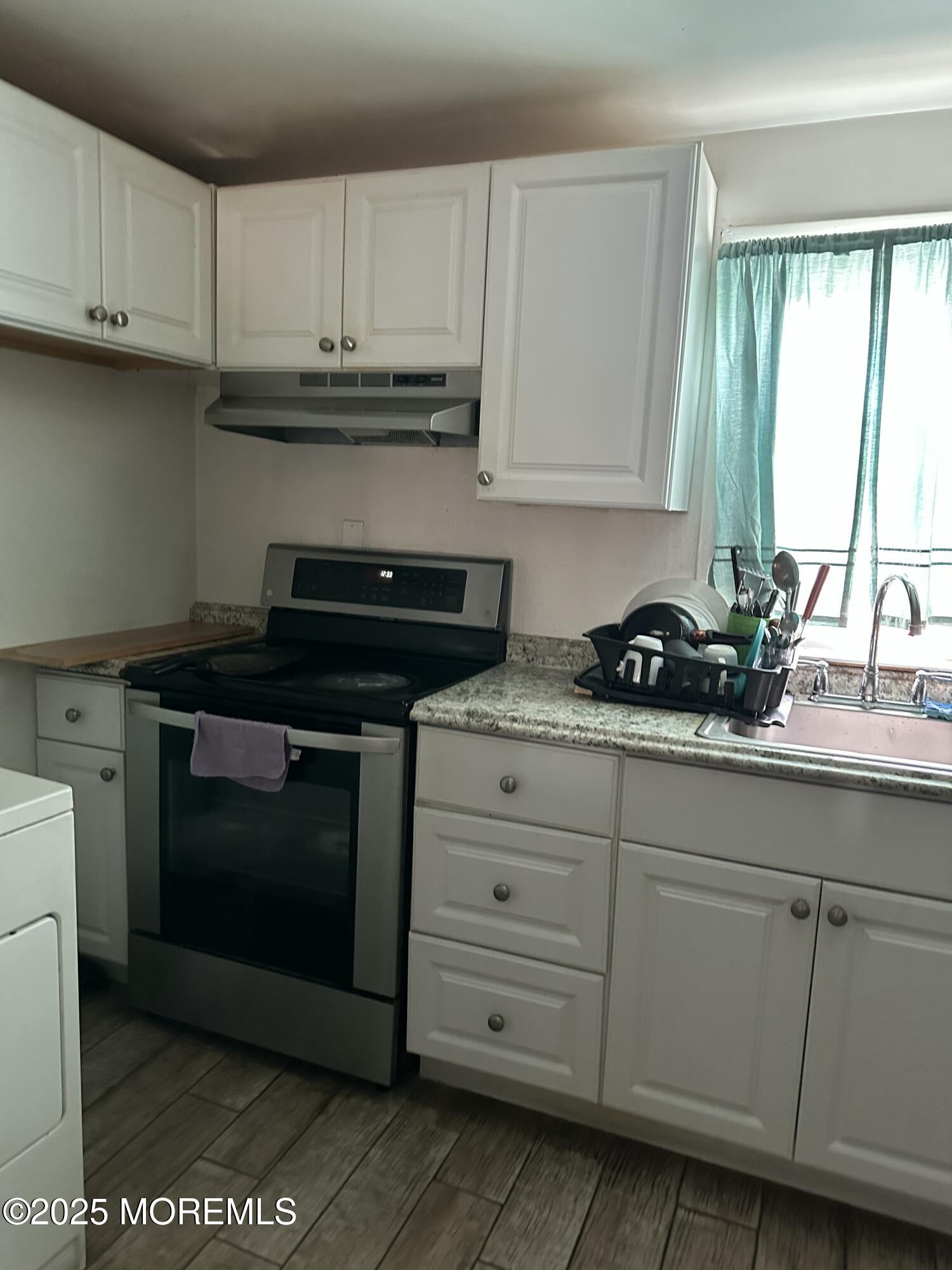 308 Myrtle Street Cliffwood, NJ 07721 - Photo 19 of 44 a kitchen with granite countertop white cabinets and a stove
