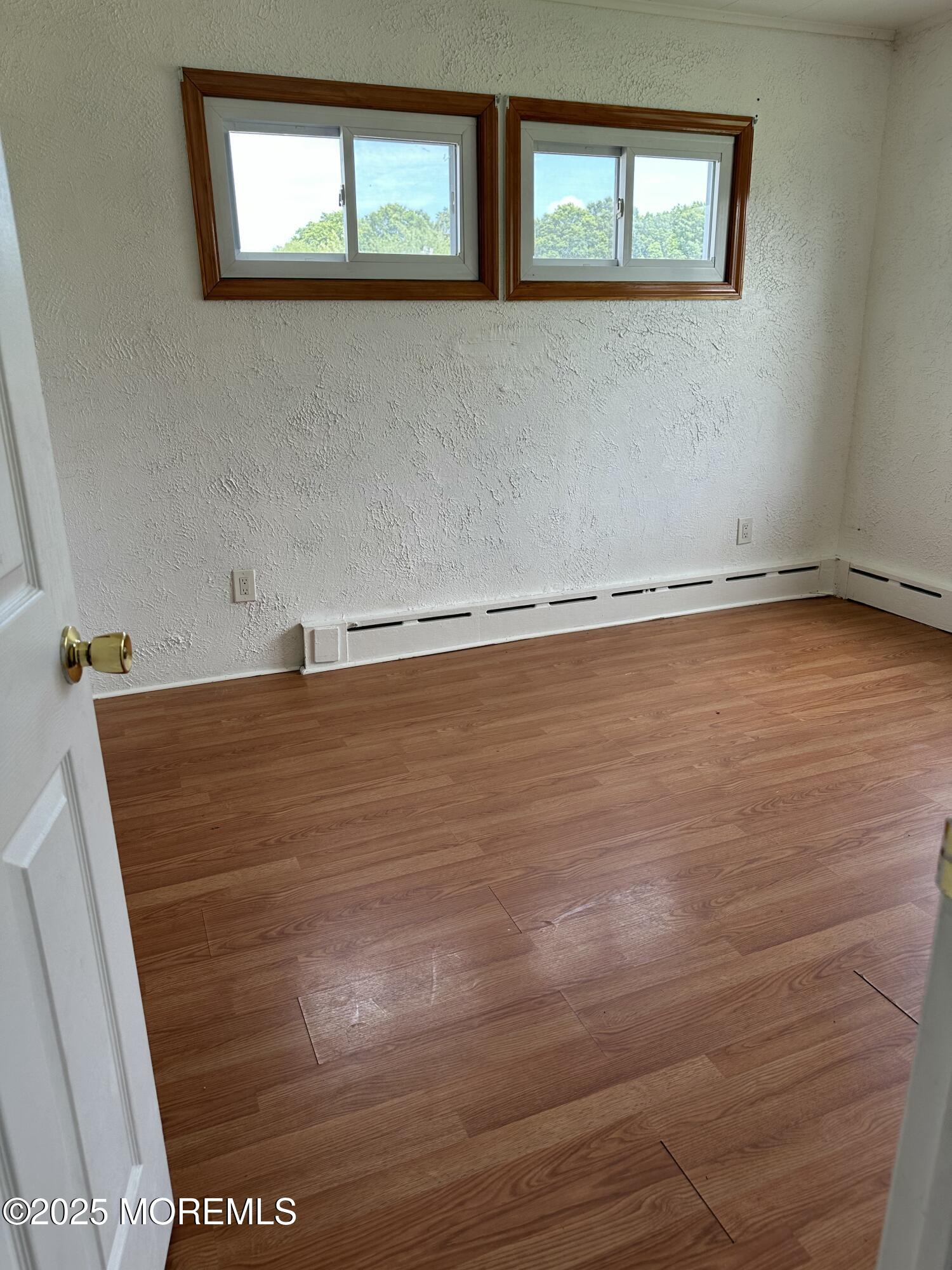 308 Myrtle Street Cliffwood, NJ 07721 - Photo 26 of 44 a view of a room with wooden floor and window