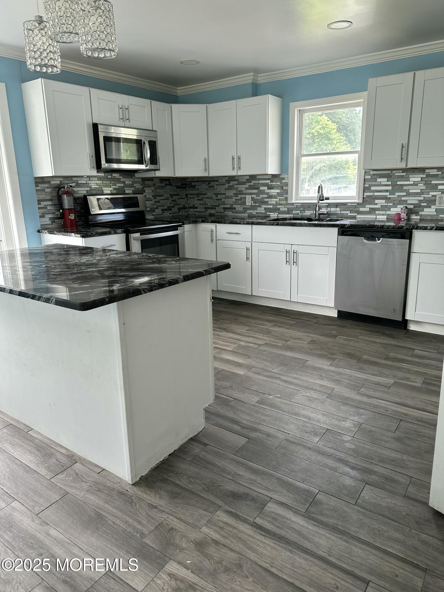 308 Myrtle Street Cliffwood, NJ 07721 - Photo 32 of 44 a kitchen with granite countertop a stove top oven a sink a counter space and cabinets