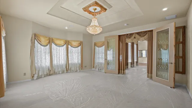 a view of a hallway with wooden floor and entryway